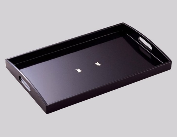 black tray with two white rabbits