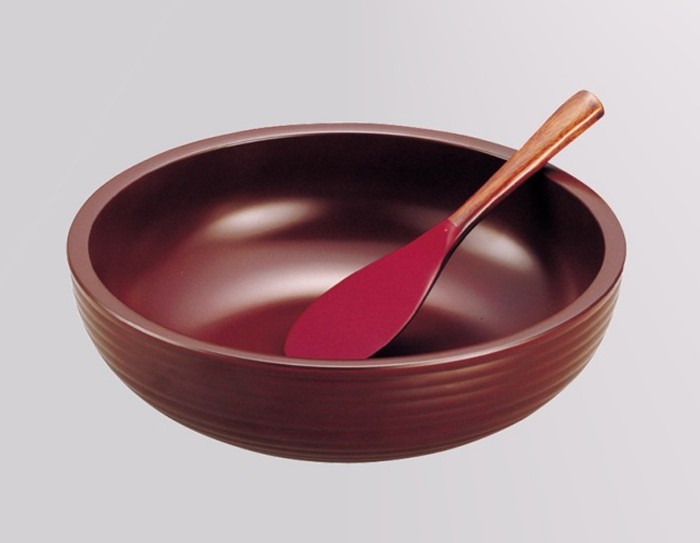 large versatile red bowl and wooden spoon